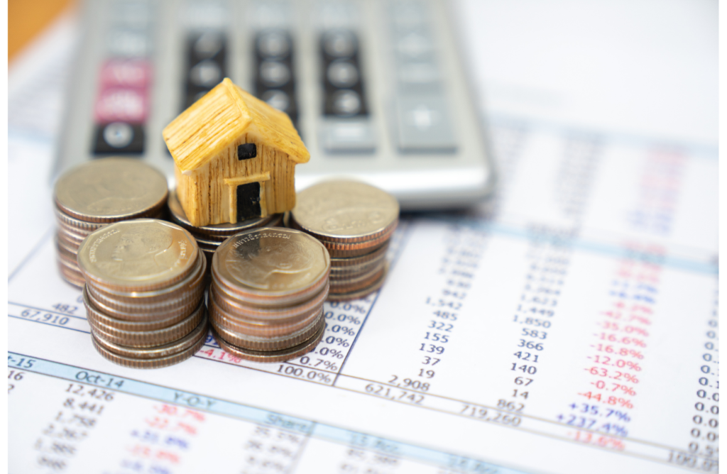 Calculator, coins, and loan documents symbolizing debt repayment and personal finance planning
